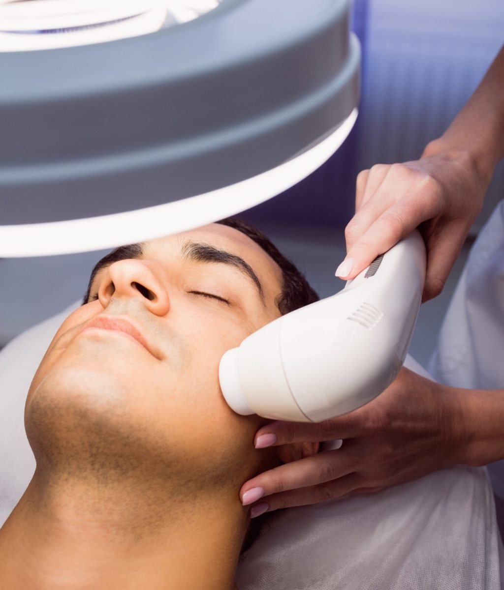 Man getting a facial massage for cosmetic treatment at clinic